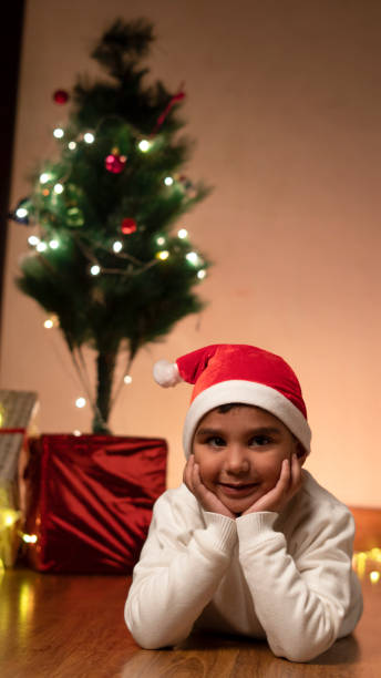 istock Happy Indian child boy wearing santa cap,christmas tree 1452030981