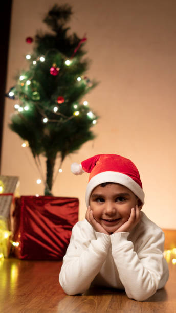istock Happy Indian child boy wearing santa cap,christmas tree 1452031179