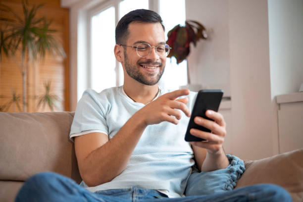 istock Shot of a young man using his smartphone 1452039737