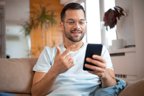 istock Shot of a young man using his smartphone 1452039743
