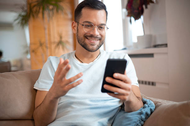 istock Shot of a young man using his smartphone 1452039781