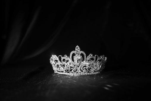 Elegance luxury royal crown on satin, silk background. Black and white