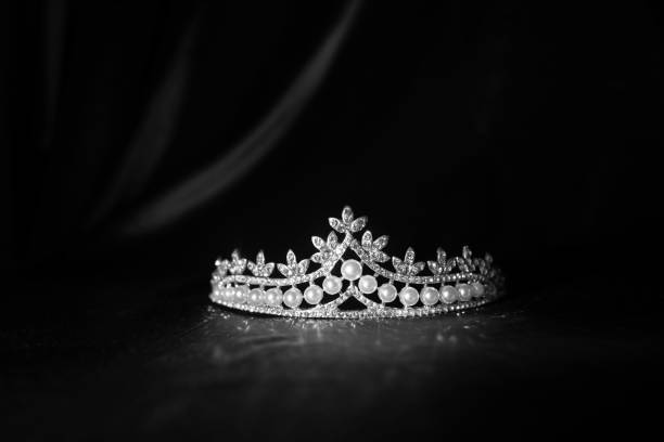 istock Luxury vintage crown on dark red satin, silk background. Black and white 1452047552