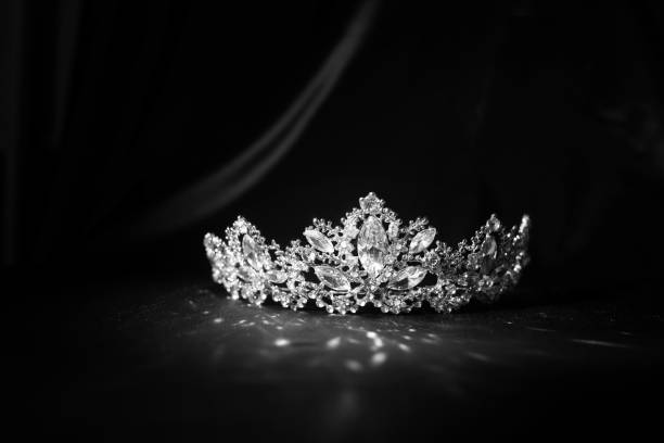 istock Luxury vintage crown on dark red satin, silk background. Black and white. 1452047577