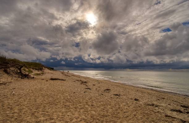 istock Scenic view of a sandy beach with a seascape in cloudy sky background 1452049799