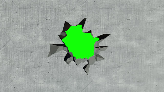 demolition of a concrete wall. a destroyed concrete wall on a green background. hole in the wall