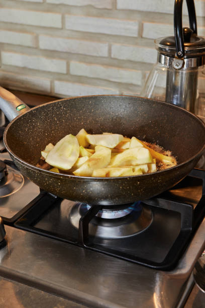 istock Frying pan on gas stove on fire with pears in syrup 1452071037