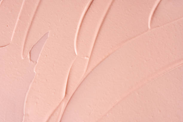 istock Pink cosmetic clay strokes background. Pink cleanser cosmetic smudge backdrop. 1452071855