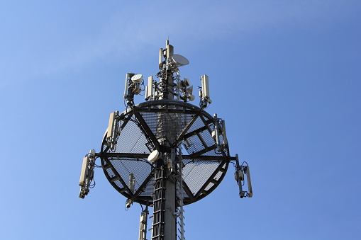 a radio antenna with blue sky