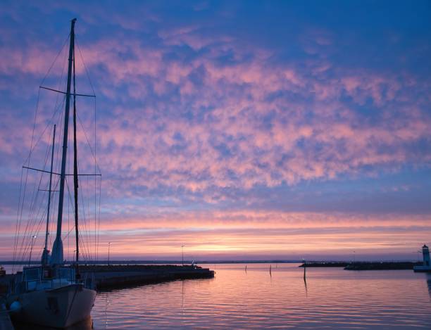 A beautiful sunset with pink clouds over the harbor.