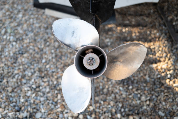 Shallow focus of a newly fitted metal outboard boat propeller. stock photo