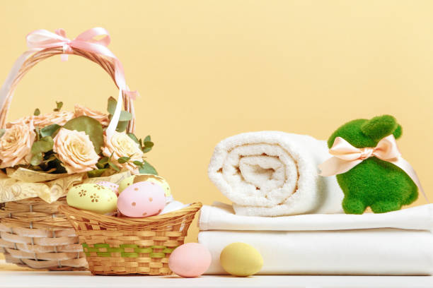 istock Easter decor and a stack of white linens and rolls of towels on the table. 1452087340