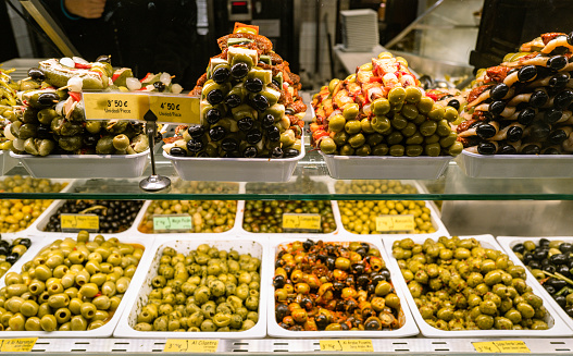 Madrid,Spain,15th December 2022 - Locals and tourists enjoying fresh food and snacks and drinks inside San Miguel food market in central Madrid, with multiple cafes and food shops available in one place. San Miguel is one of the most popular attractions for visitors to Madrid.