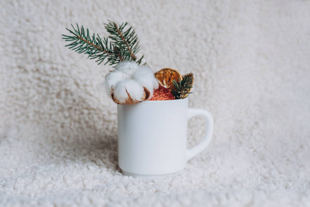 istock Blank white cup with Christmas decoration on white cozy background. Mockup white cup. 1452107595