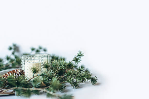 istock Christmas or New Year decoration background: fur-tree branches with candles. Blurred, soft focus. 1452107656
