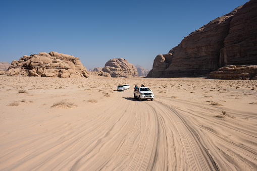 Wadi Rum, jordan - October 30 2022: Toyota Hilux Pickup Trucks Driving through the Desert in Wadi Rum, Jordan