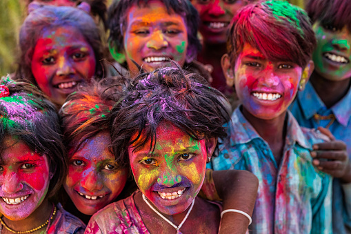 Group of Indian children playing happy holi in Rajasthan, India. Holi, the festival of colors, is a religious festival in India, celebrated, with the color powders, during the spring.