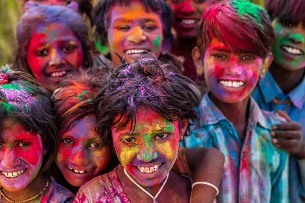 Photo of Colors of India - Indian children playing colorful powders during holi, India