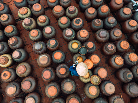 Jars of Tuong in ancient house yard, a kind of fermented bean paste made from soybean and commonly used in Vietnamese cuisine