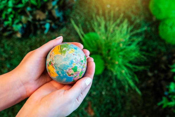 istock Planet Earth inside green garden in the hands, ecology and climate content 1452122549