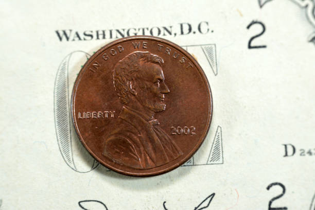 istock 1 One American cent coin series 2002, Obverse side features Abraham Lincoln the 16th president of the United States Of America who preserved the Union, old USA vintage retro coin on USD banknote 1452128038