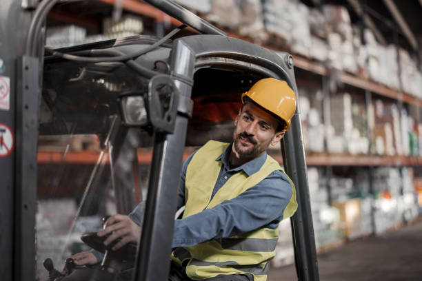istock Male worker driving a forklift in the warehouse storage 1452130966