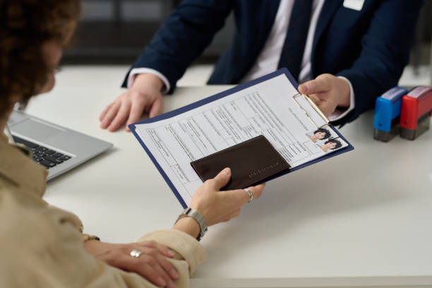 istock Close up of woman holding visa application form 1452132434