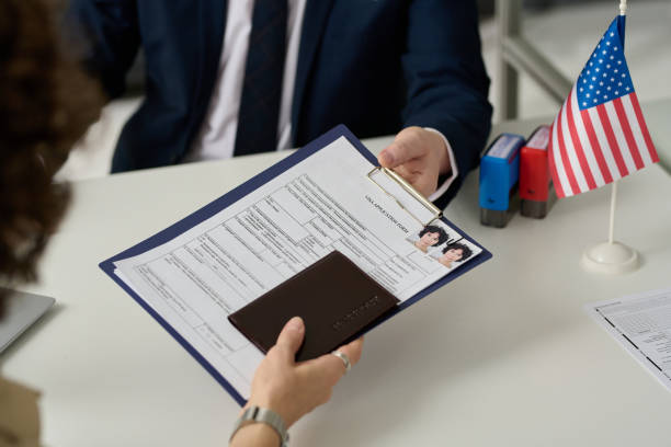 istock Woman handing visa application in US Immigration office 1452132440
