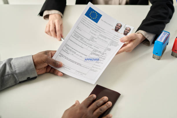 istock Top view of black man holding approved visa 1452132464