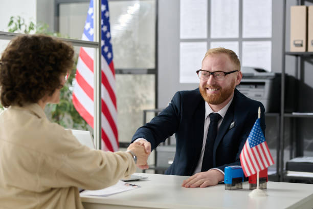 Consultant shaking hands with client stock photo