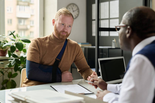 istock Man talking to insurance broker after accident 1452132541