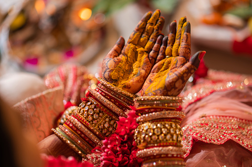 Indian wedding ritual closeup detail photo bride hand haldi ceremony stock photo.