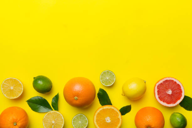 istock Fruit background. Colorful fresh fruits on colored table. Orange, lemon, grapefruit Space for text healthy concept. Flat lay, top view, copy space 1452137160