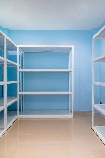 istock Empty white shelves in blue storage room 1452137287
