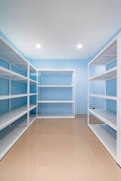 istock Empty white shelves in blue storage room 1452137292