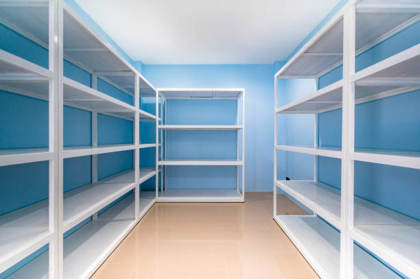istock Empty white shelves in blue storage room 1452137307