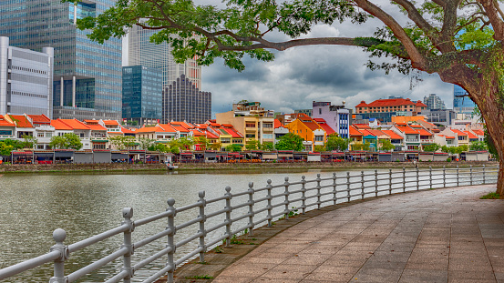 A view of the Clark Key area in Singapore  The photo has been taken on a dramatic cloudy day from a park.