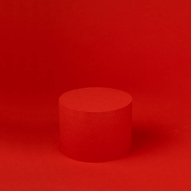 istock Rich red festive stage mockup with single cylinder podium on table for presentation cosmetic products, gifts, goods in elegant modern minimalist style, copy space, square. Template for advertising. 1452139548