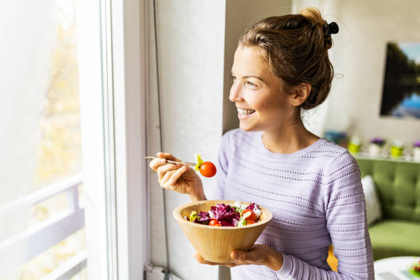 istock Woman eating healthy vegetable salad 1452142898
