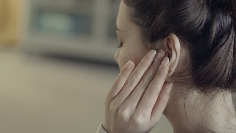 Young woman with ear pain