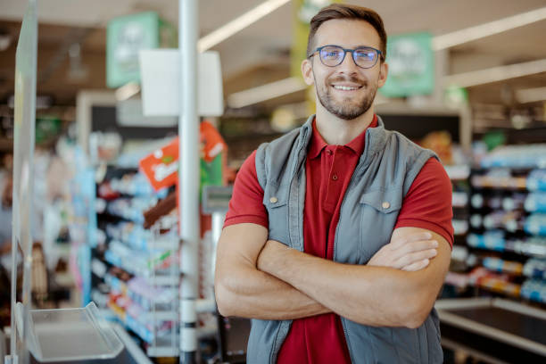 istock Portrait of a Smiling Shopkeeper Looking at Camera 1452146593