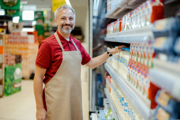 istock Mature Supermarket Staff Looking at Camera 1452147973