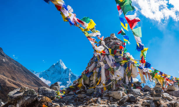 istock Buddhist pray flags flying high in Himalaya mountains panorama Nepal 1452148084