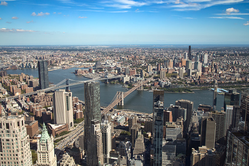 Long Island City with Pulaski bridge with the traffic on it. Panoramic view of Astoria and Roosevelt Island and Upper East Side Manhattan over the Queensboro Bridge.