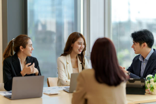 istock Group of young Asian business people with the creative work, talk and exchange ideas shared at the meeting. 1452158362