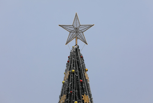 golden christmas star on top of the tree