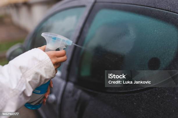 Closeup Of A Woman Using A Defrost Spray On Her Car Window Stock Photo -  Download Image Now - iStock