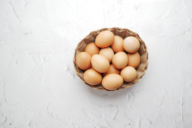 istock top view of eggs in a bowl on white background 1452169635