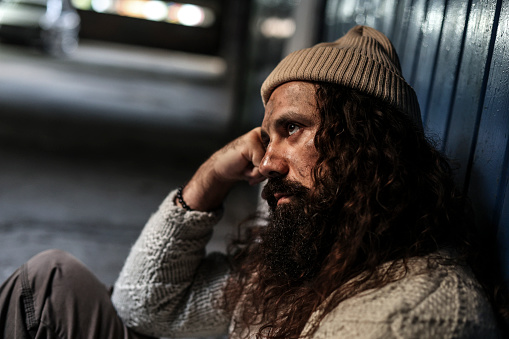 Homeless man on begging on the street. About 45 years old, Caucasian male.