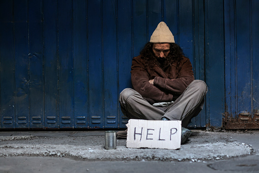 Homeless man on begging on the street. About 45 years old, Caucasian male.